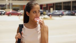 Business Woman Eating Donut For Breakfast Commuting To Work.jpg Business Woman Eating Donut For Breakfast Commuting To Work.jpg