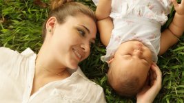 Mother Kissing Little Baby Daughter Laying Closed On Grass.jpg Mother Kissing Little Baby Daughter Laying Closed On Grass.jpg